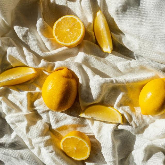 Citrons et quartiers de citron disposés sur un drap